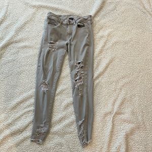 Grey denim distressed jeans.